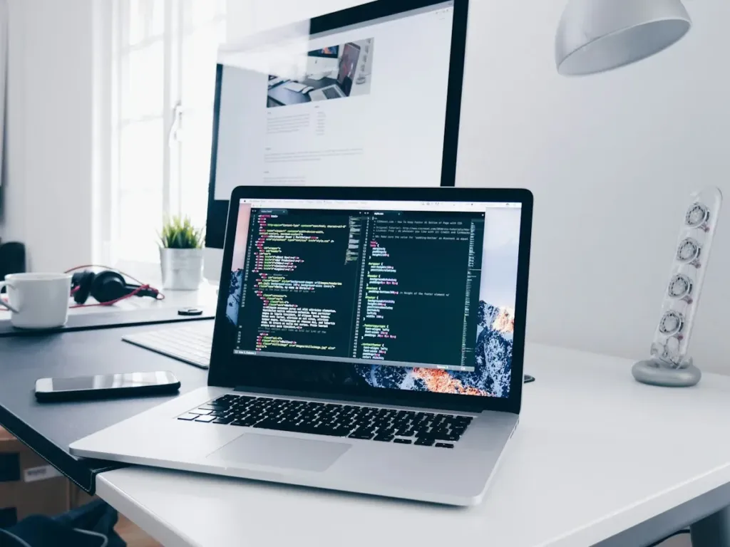 Laptop with website code on a developer desk