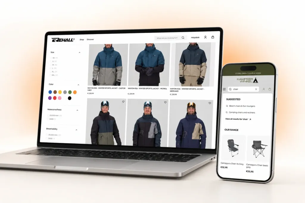 Laptop showing Rehall's men's ski jacket collection with size, colour, waterproofness and breathability filters, beside a phone showing Kampeerwinkel Roermond's predictive search results for 'chair'